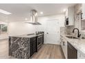 Bright kitchen with an island, stainless steel range hood, granite countertops and sleek appliances at 2142 E Palmcroft Dr, Tempe, AZ 85282