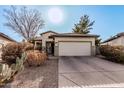 Charming single-story home featuring desert landscaping and an attached two-car garage at 22288 S 214Th S St, Queen Creek, AZ 85142