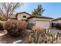 Inviting single-story home featuring desert landscaping and an attached two-car garage at 22288 S 214Th S St, Queen Creek, AZ 85142