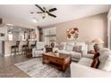 Comfortable living room with tile flooring, white sofas, and a view of the adjacent kitchen at 227 W Lantern Way, San Tan Valley, AZ 85143