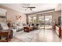 Open living area with tiled floors, white sofas, and natural light from sliding glass doors at 227 W Lantern Way, San Tan Valley, AZ 85143