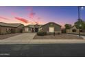 Well-maintained home with a manicured front yard and a freshly paved driveway at 22949 W Yavapai St, Buckeye, AZ 85326