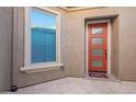 Eye-catching coral front door with a 'Hello' mat and textured stucco walls at 23072 N 98Th N Dr, Peoria, AZ 85383