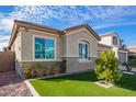 Angle view of stucco home featuring well-maintained synthetic lawn and desert landscaping at 23072 N 98Th N Dr, Peoria, AZ 85383