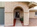 Inviting arched entryway, and decorative brickwork showcasing a welcoming front entrance to the home at 2671 W Bentrup St, Chandler, AZ 85224