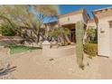 Beautiful home entrance with a stone walkway, desert landscaping, and covered front porch at 27561 N 84Th Dr, Peoria, AZ 85383