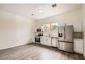 Bright kitchen featuring white cabinets, stainless steel appliances, and modern flooring at 2929 N 55Th Pl, Phoenix, AZ 85018