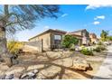 The side yard is xeriscaped with desert plantings and has view fencing for privacy at 34014 N 43Rd St, Cave Creek, AZ 85331