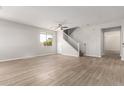 Bright living room with tile floors, stairs, ceiling fan, and natural light at 4019 W Valley View Dr, Laveen, AZ 85339