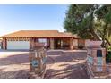 Charming single-story brick home featuring a well-maintained yard and inviting walkway at 4323 W Villa Theresa Dr, Glendale, AZ 85308