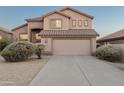 Inviting tan stucco home featuring a tile roof, desert landscaping, and an attached two-car garage at 4625 E Thorn Tree Dr, Cave Creek, AZ 85331