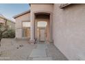 Inviting covered front entrance to a tan stucco home featuring a tile roof and desert landscaping at 4625 E Thorn Tree Dr, Cave Creek, AZ 85331