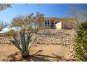 Image displaying the natural landscaping around the property, with rocks and native plants at 50408 N 22Nd Ave, New River, AZ 85087