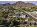 Beautiful home exterior featuring mature trees, manicured landscaping, a long driveway, and mountain views at 5144 E Calle Del Medio --, Phoenix, AZ 85018