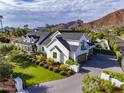 Expansive home exterior with mountain views, manicured landscaping, a driveway, and multiple garage parking at 5144 E Calle Del Medio --, Phoenix, AZ 85018