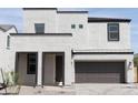 Modern two-story home showcasing a brown garage door and white facade at 5826 S Daisy Patch Pl, Phoenix, AZ 85040