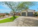 Beautiful home with lush artificial turf and a long, winding driveway leading to a spacious three-car garage at 891 W Palo Brea Dr, Litchfield Park, AZ 85340