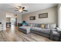 Inviting living room featuring hardwood floors, a comfortable sofa, and a ceiling fan at 932 W Julie Dr, Tempe, AZ 85283