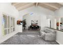 Bright and airy living room with vaulted ceilings, fireplace, and sliding glass doors to the backyard at 9901 N 51St Pl, Paradise Valley, AZ 85253