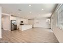 Bright, open kitchen with a large island, stainless steel appliances, and white cabinetry at 10209 E Ursula Ave, Mesa, AZ 85212