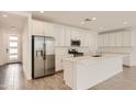 Well-lit kitchen featuring a large island, stainless steel appliances, and white cabinetry at 10209 E Ursula Ave, Mesa, AZ 85212