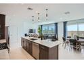 Open concept kitchen with stainless steel appliances, center island, and seamless connection to living and dining areas at 10209 E Ursula Ave, Mesa, AZ 85212