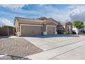 Spacious home featuring an expansive driveway and three-car garage at 10449 E Lomita Ave, Mesa, AZ 85209