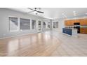 Open-concept living room with wood flooring and ample natural light at 10449 E Lomita Ave, Mesa, AZ 85209