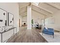 Inviting living room featuring vaulted ceilings, a brick fireplace, and stylish decor at 10540 N 78Th Pl, Scottsdale, AZ 85258