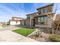 Attractive two-story home with three car garage, xeriscaping, and artificial turf at 11679 W Parkway Ln, Avondale, AZ 85323