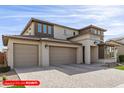 Two-story home with a neutral color palette featuring a three-car garage and drought-resistant landscaping at 11679 W Parkway Ln, Avondale, AZ 85323