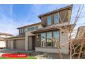 Exterior of two-story home with drought-resistant landscaping, three-car garage, and neutral color palette at 11679 W Parkway Ln, Avondale, AZ 85323