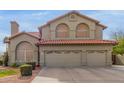 Beautiful two-story home featuring a tile roof and attached three-car garage at 12443 W Monte Vista Rd, Avondale, AZ 85323