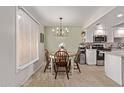 Charming dining area complemented by a modern chandelier and bright natural light at 1310 S Pima St # 34, Mesa, AZ 85210