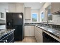 Open kitchen featuring granite countertops, white cabinetry, and stainless steel appliances at 1428 E Las Palmaritas Dr, Phoenix, AZ 85020