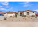 Well-maintained home featuring desert landscaping, a tile roof, and a welcoming front entrance at 14612 W Edgemont Ave, Goodyear, AZ 85395