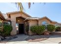 Welcoming front entrance features desert landscaping and a covered porch at 15479 W Whitton Ave, Goodyear, AZ 85395