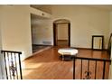 Spacious living room with wood flooring, archway, white walls, and natural light at 16029 N 36Th Dr, Phoenix, AZ 85053