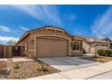 Attractive single-story home with a tile roof, desert landscaping and a two car garage at 16593 W Alameda Rd, Surprise, AZ 85387