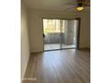 Bright living room featuring wood floors and sliding doors leading to an outdoor space at 17017 N 12Th St # 1135, Phoenix, AZ 85022