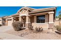 Beautiful single-story home with desert landscaping, a covered porch, and an attached garage at 17642 W Pershing St, Surprise, AZ 85388