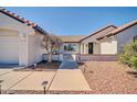 Inviting front entrance featuring a tiled roof, desert landscaping, and a view to the charming front door at 21614 N 138Th Ave, Sun City West, AZ 85375