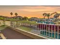 Scenic balcony view showcasing a lush golf course, serene pond, and vibrant bougainvillea in a tranquil setting at 21915 N 65Th Ave, Glendale, AZ 85310