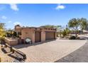 Expansive brick paver driveway leading to a spacious two-car garage with plenty of parking space at 25621 N Cordova Ln, Rio Verde, AZ 85263