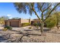 Lovely desert landscaping with mature trees, rocks, and cacti creating a peaceful ambiance at 25621 N Cordova Ln, Rio Verde, AZ 85263