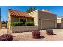 Inviting home featuring a two car garage, a tile roof, and low maintenance desert landscaping at 2848 E Brown Rd # 30, Mesa, AZ 85213