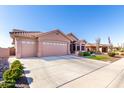 Single-story home with 3-car garage, long driveway, desert landscaping with gravel, small lawn and palm trees at 2854 S Berrywood --, Mesa, AZ 85212