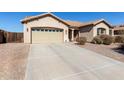 Beautiful home showcasing a well-maintained lawn and an inviting entrance, complete with an attached two-car garage at 3034 E Coconino Dr, Gilbert, AZ 85298