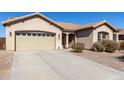 Inviting one-story home featuring a two-car garage, desert landscaping, and a charming front entry with a tile roof at 3034 E Coconino Dr, Gilbert, AZ 85298