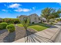Charming single-story home with well-maintained landscaping, desert rock accents, and a freshly cut lawn at 30488 N 126Th Dr, Peoria, AZ 85383